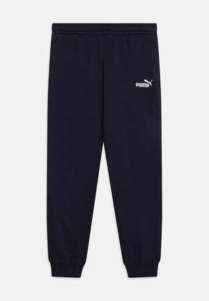 Pantaloni della tuta blu navy con una cintura elastica, polsini alle caviglie e un logo Puma bianco sul lato sinistro superiore. Tessuto morbido.
