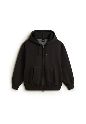 Black zip-up hoodie made of soft fabric with a front pocket, drawstring hood, and ribbed cuffs. Logo patch on the lower left.