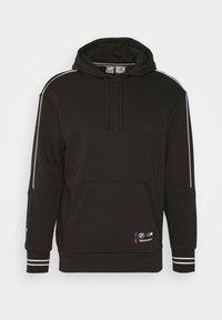 Felpa nera con cappuccio e strisce bianche sulle maniche, tasca frontale e patch del logo BMW Motorsport. Realizzata in tessuto liscio e morbido con polsini a coste.