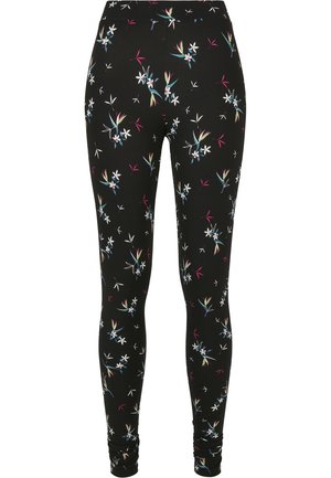 Schwarze Leggings mit floralen Mustern in Weiß, Blau und Rosa Akzenten. Hergestellt aus dehnbarem Stoff mit einer glatten Textur.