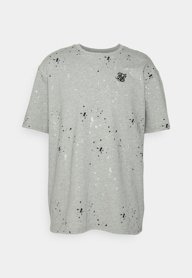 Grå T-shirt i bomull med avslappnad passform. Har ett stänkmönster i svart och vitt, samt en liten logotyp på bröstet.