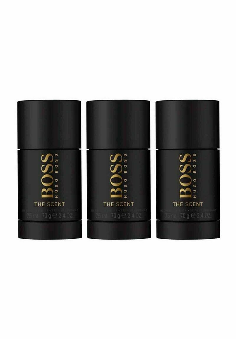 Kolme sylinterimäistä mustaa deodoranttipulloa, joissa on kultainen teksti "BOSS HUGO BOSS THE SCENT", jokainen merkitty 75 ml ja 70 g.