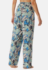 Pantalons larges multicolores avec un motif floral et de feuilles en bleu et vert, dotés d'une taille élastique et en tissu doux et léger.