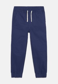 Pantaloni jogger de culoare bleu marin, cu talie elastică, șnur ajustabil, buzunare laterale și manșete strânse la glezne. Finisaj de țesătură netedă.