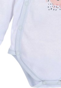 Witte katoenen bodysuit met lange mouwen, lichtblauwe accenten, drukknopen en een bedrukt ontwerp met roze en zwarte accenten.