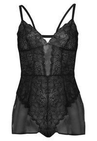 Camiseta de encaje negro con tirantes ajustables, que presenta un patrón floral, tela transparente y bordes festoneados, diseñada con un corte relajado.