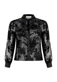 Black sheer blouse with floral embroidery, classic collar, button closure, and long sleeves with black cuffs. Textured floral pattern throughout.