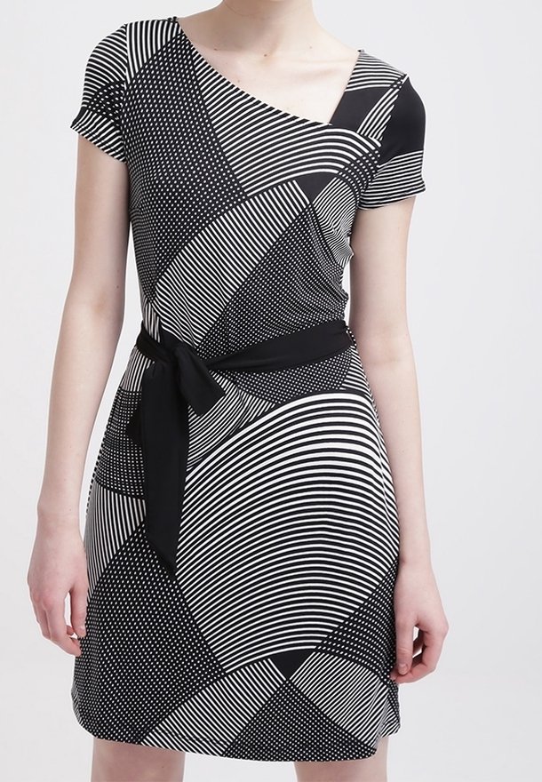 Svartvit mönstrad klänning med korta ärmar, asymmetrisk halsringning, midjeband, med ränder, prickar och olika geometriska former.