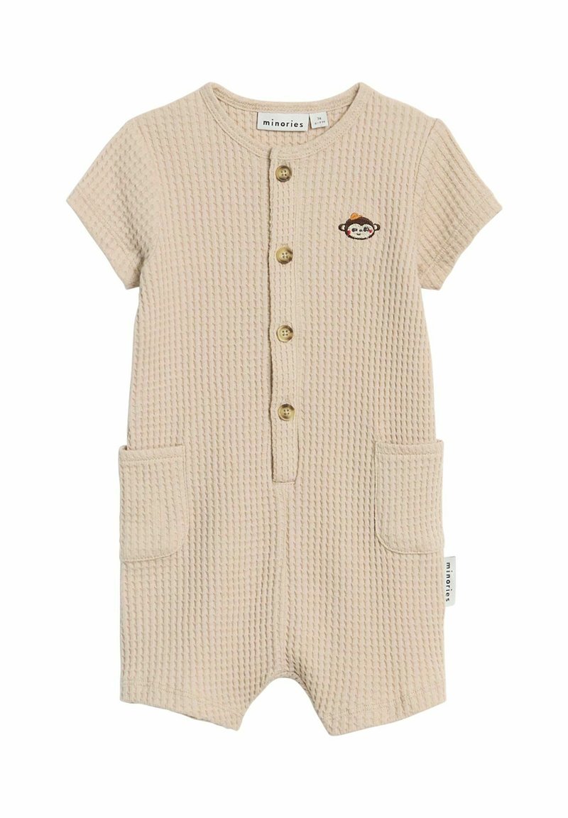 Grenouillère bébé beige texturée à manches courtes, boutons sur le devant, deux poches et un petit visage de singe brodé sur la poitrine.
