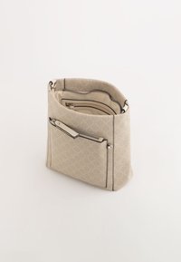 Sac à main beige clair avec un motif texturé, poche avant zippée, ferrures en argent et une finition intérieure lisse. Forme carrée avec des bords doux.