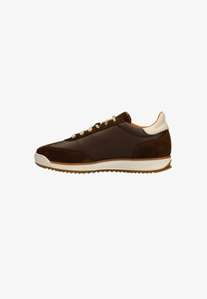 Brown suede and leather sneaker with a cream accent at the heel, featuring beige laces and a rubber sole with a textured grip.