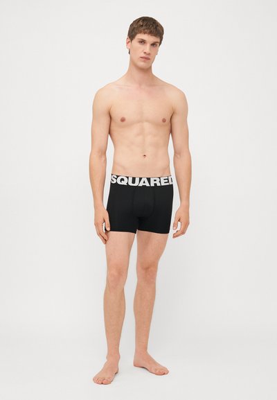 Černé boxerky s bílým logem "SQUARED" na pase, přiléhavý design, měkká látka a hladký povrch.