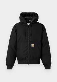 Črna Carhartt kapuca s sprednjim zadrgo, kenguru žepom, rebrastimi manšetami in logotipom na žepu.