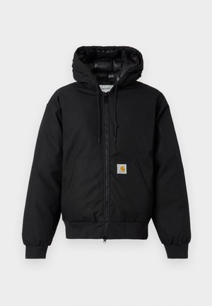 Črna Carhartt kapuca s sprednjim zadrgo, kenguru žepom, rebrastimi manšetami in logotipom na žepu.