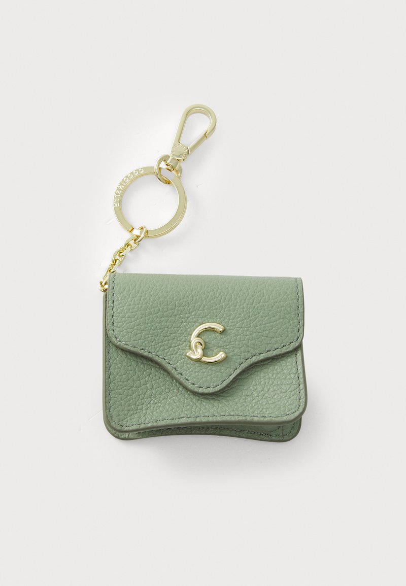 Green leather wallet with a textured finish, curved flap, gold clasp, and keychain attachment. Features a logo accent.