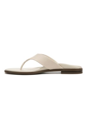 Light beige flip-flop sandal with a textured strap, flat sole, and minimalistic design. Slightly raised brown accent around the sole.