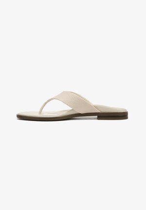 Light beige flip-flop sandal with a textured strap, flat sole, and minimalistic design. Slightly raised brown accent around the sole.