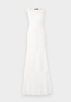 White maxi dress made of textured fabric, featuring a fitted bodice, ruffle trim at the neckline, and a flared hem with geometric patterns.