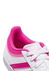 Vita sneakers med rosa textilaccenter, snören och ränder. Slät lädermaterial med vadderad krage för komfort.