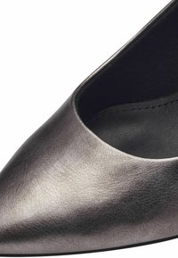 Metalická šedá vysoká botička s špičatou špičkou a hladkým povrchem. Má nízký střih na svršku a černou podšívku.