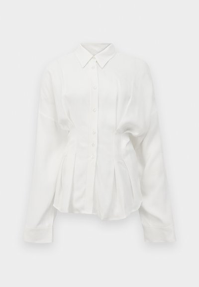 White long-sleeve shirt, features a pointed collar, button front, and pleated design. Made from a smooth fabric with a slight sheen.