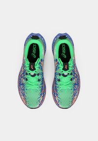 Zapatillas de running Asics con una parte superior de malla verde, diseño de manchas multicolores, acentos azules y cordones en contraste.