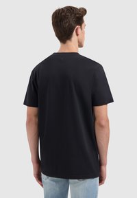 Zwart T-shirt met korte mouwen van katoen, met een ronde hals en een soepele textuur, met een subtiel detail aan de achterkant.