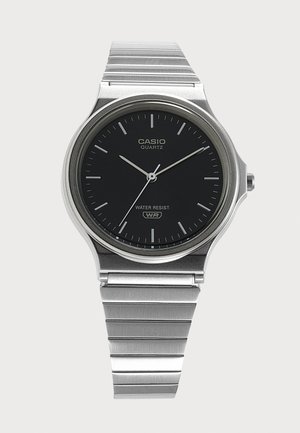 Zilverkleurig Casio quartz horloge met zwarte wijzerplaat, zilverkleurige uurmarkeringen, drie wijzers en metalen schakels, toont 10:10:36.