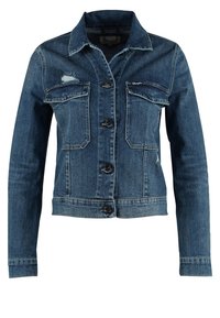 Tumma sininen farkkutakki klassisella kauluksella, napitettavalla edellä, kahdella etutaskulla ja kuluneilla yksityiskohdilla kankaassa.