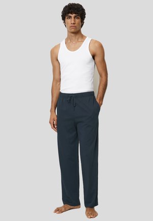 Lichte marineblauwe loungebroek met een elastische tailleband en een trekkoord. Gecombineerd met een aansluitend wit tanktop.