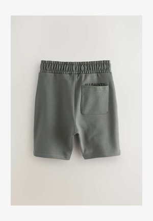 Pantaloni corti grigi in cotone con vita elastica, dotati di una tasca sul retro e testo nero "ALL SAINTS" sul lato sinistro. Texture liscia.