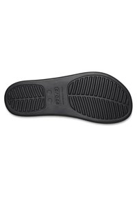 Suola di scarpa in gomma nera con un modello testurizzato e scolpito, dotata di scanalature per trazione e stabilità. Il marchio è chiaramente visibile.