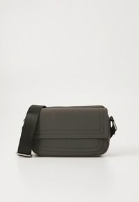 Gray crossbody bag made of smooth material, featuring a flap closure, decorative stitching, and an adjustable black strap.