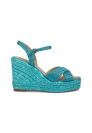 Teal wedge sandaaltjes met gevlochten jute platform en enkelbandje, voorzien van een geperforeerde synthetische bovenkant met metalen studs voor extra detailing.