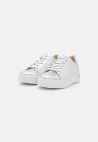 Silver sneakers with a smooth, metallic finish. White rubber sole and laces. Rounded toe and subtle side accents. Minimalist design.