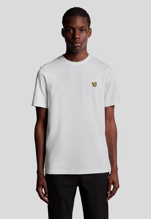 Witte katoenen T-shirt met korte mouwen, ronde hals, voorzien van een klein geel vlinderlogo op de linkerborst. Vlakke zoomontwerp.