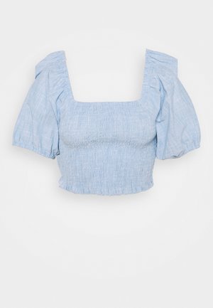 Top corto azzurro chiaro con corpetto arricciato, scollatura quadrata e maniche a sbuffo. Realizzato in tessuto texturizzato con orlo arricciato.