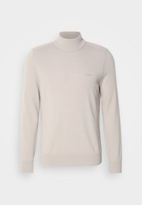 Pull à col roulé beige clair en tissu tricoté. Comprend des poignets et un col côtelés, logo brodé sur la poitrine. Coupe classique.