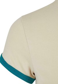 Beige t-shirt with a ribbed texture, featuring a teal accent on the short sleeves. Close-up view of the shoulder and sleeve detail.