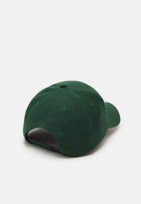 Green baseball cap crafted from cotton, featuring a curved brim, ventilation holes, and adjustable strap at the back. Simple design.