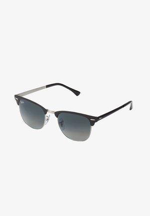 Black and silver sunglasses with a cat-eye shape, gradient lenses, and metallic accents on the frame. Plastic arms with grey tips.