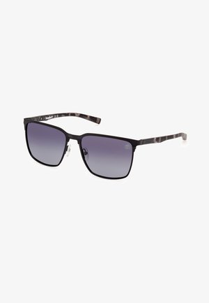 Occhiali da sole quadrati con montatura nera e lenti grigie scure sfumate. Le astine presentano un motivo marmorizzato in grigio e nero.