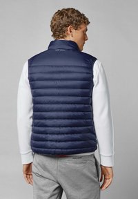 Mornarica puffer prsluk s horizontalnim izrezanim uzorkom, visoki ovratnik i lagana tekstura. Sadrži "Pepe Jeans" logo na vratu i na pojasu.