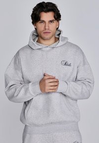 Gray hooded sweatshirt with a relaxed fit, made from soft material. Features a front pocket and embroidered logo on the chest.