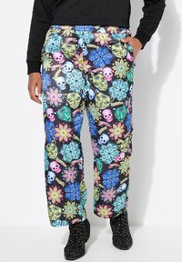 Pantaloni colorati con uno sfondo nero e motivi floreali e teschi in rosa, blu, verde e giallo. Fit morbido con una vita elastica.