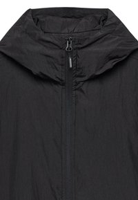 Lightweight black jacket featuring a high collar, full front zipper, and smooth texture. No visible patterns or hardware accents.
