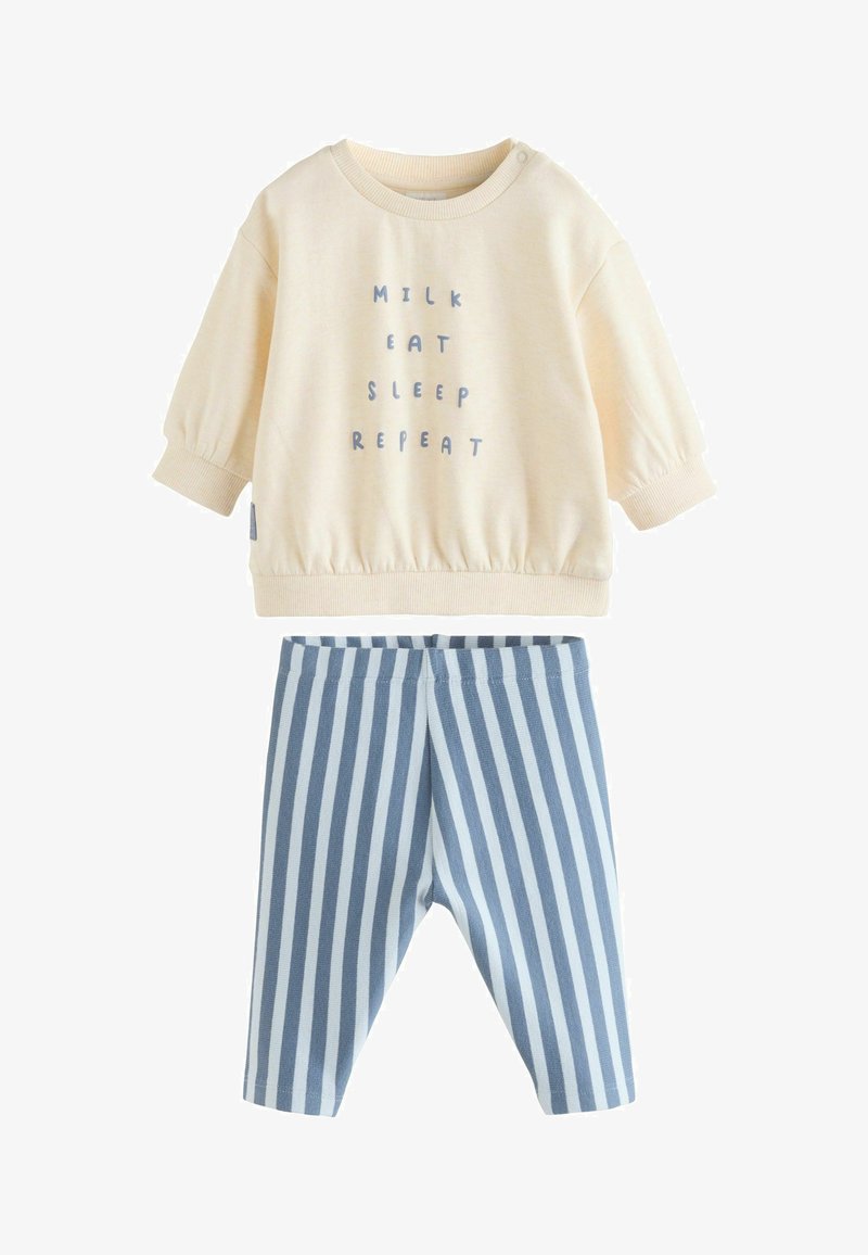 Cream sweatshirt with text “MILK EAT SLEEP REPEAT,” paired with blue and white striped soft pants. Both made of cotton.