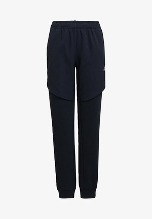 Tmavě modré tepláky s elastickým pasem, vrstveným designem vpředu a zúženými nohavicemi. Měkká, texturovaná látka.