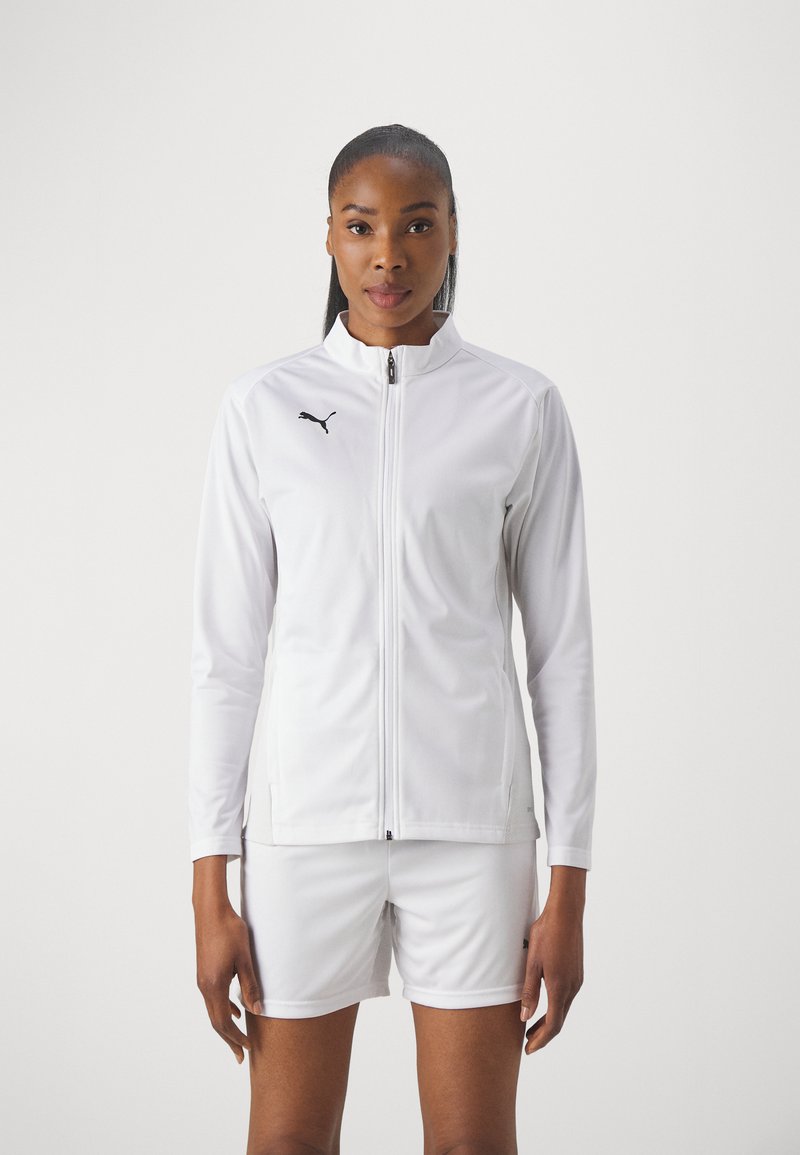 White athletic jacket with a high collar, featuring a black Puma logo on the chest, paired with matching white shorts. Smooth fabric texture.