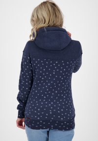 Hoodie bleu marine avec un motif à pois. Doté d'une capuche à cordon, de manches longues et d'une finition texturée. Agrémenté d'un petit logo.